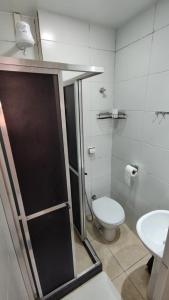 a bathroom with a shower and a toilet and a sink at Rio Deal Guest House in Rio de Janeiro