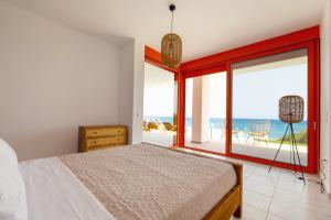 a bedroom with a bed and a view of the ocean at Villa Seven in Lachania