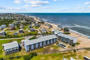 an aerial view of a beach with buildings and the ocean at Daly Vibes in Rodanthe