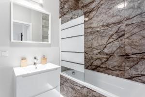 a bathroom with a sink and a mirror at Praga Residence Premium in Warsaw +22 photos
