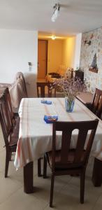 a dining room table with a vase of flowers on it at Sea View in Alikí