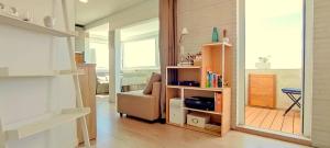 a living room with a couch and a book shelf at Panorama Penthouse in Espinho