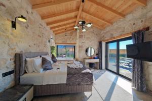 a bedroom with a bed in a stone wall at Ader villa 2 in Fethiye