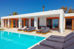 a villa with a swimming pool next to a house at Villa Seven in Lachania