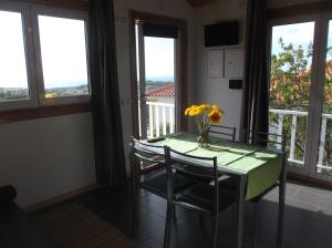 a dining room with a table and chairs and windows at Casa do Morro in Sintra +12 photos