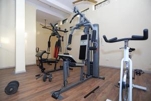a gym with several exercise bikes in a room at Capital O 7302 The Huespedes in Gurgaon