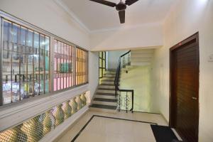 a hallway with a staircase with a door and a window at Hotel Sai Leela in Puri