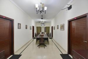 a long dining room with a table and chairs at Hotel Sai Leela in Puri
