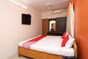 a bedroom with a bed and a tv on the wall at New Mega Palace in Bankipur