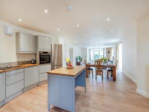 a kitchen with white cabinets and a dining room at The Oast - Uk43087 in Preston