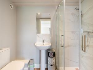 a white bathroom with a sink and a shower at The Oast - Uk43087 in Preston