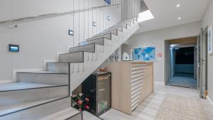 a staircase in a house with a glass wall at Cliff Haven in Struisbaai