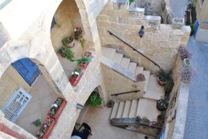 an overhead view of a building with stairs and plants at Dar Ghax-Xemx Farmhouse in Victoria