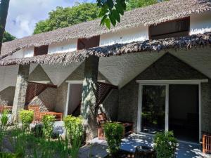 a resort building with a thatched roof at Kintana Hotel SPA in Dzamandzar