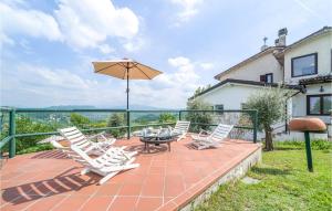 a patio with chairs and a table and an umbrella at Villa Poss in Villa +52 photos