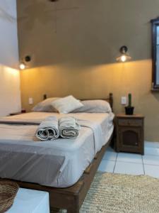 1 dormitorio con 1 cama con 2 toallas en Anana Coliving en Playa del Carmen