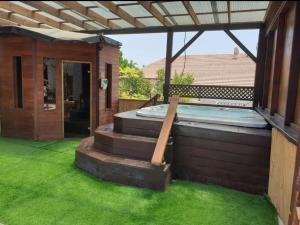 a hot tub in the backyard of a house at The Pearl of the Golan - Pnina BaGolan in Had Nes