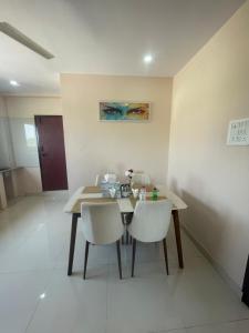 a dining room with a table and two chairs at Reef Terrace Unit in Hyderabad