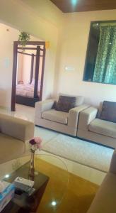 a living room with a couch and a mirror at Reef Terrace Unit in Hyderabad