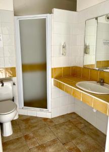 a bathroom with a toilet and a sink at Studio Coin nuit 205 Résidence Les Acacias in Anduze