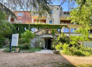 an external view of a building with a staircase at Studio Coin nuit 205 Résidence Les Acacias in Anduze