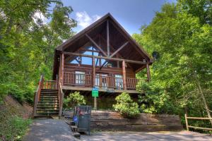 a large wooden house with stairs leading up to it at A Secluded Bearadise #247 in Sevierville