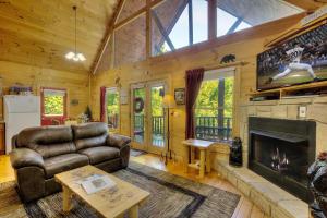 a living room with a couch and a fireplace at A Secluded Bearadise #247 in Sevierville