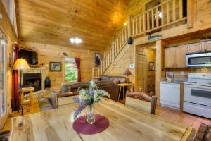 a living room and kitchen with a table in a cabin at A Secluded Bearadise #247 in Sevierville