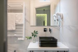 a bathroom with a sink and a mirror at Smart Room Abbadia S S - Camere LuxuryModernStyle con Cucina Condivisa in Abbadia San Salvatore +29 photos