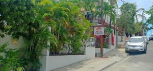 ein Auto, das auf einer Straße neben einem Gebäude geparkt ist in der Unterkunft Hotel Casa Coco in Boca Chica