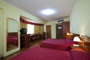 Postel nebo postele na pokoji v ubytování Albergo Ristorante Uliveto