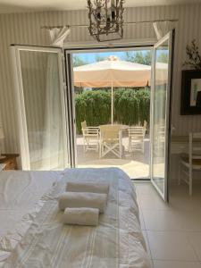 a bedroom with a bed and a patio with an umbrella at Casa di Terra in Gythio