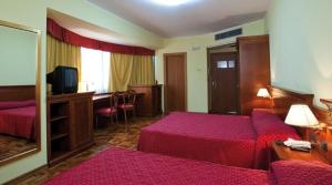 Postel nebo postele na pokoji v ubytování Albergo Ristorante Uliveto