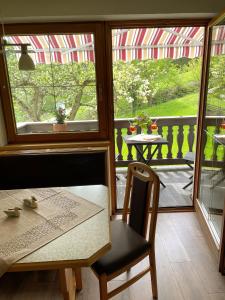 a table and chair in a room with a balcony at Ferienwohnung Lisal in Mutters