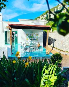 a house with a deck with tables and chairs at B&B L'Agapanto in Capri