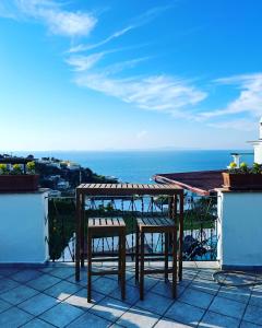 a table and two chairs on a balcony with the ocean at B&B L'Agapanto in Capri