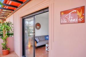 a glass door to a living room with a couch at Villa Fénix - Oasis in Natural Reserve in Lajares