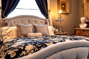 a bedroom with a bed and a statue in a window at South Broadway Manor in Scottdale