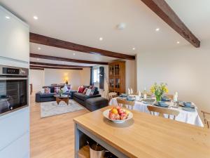 a kitchen and living room with a bowl of fruit on a table at Oast View - Uk43088 in Preston