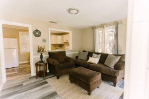 a living room with a couch and a chair at Cozy Downtown Gem Fully Equipped Free Parking in Mobile
