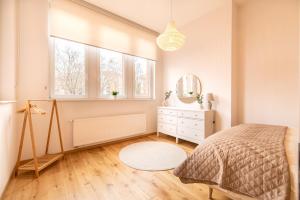 a bedroom with a bed and a dresser and a window at Casita Loft in Ludwigshafen am Rhein