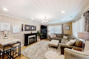 a living room with a couch and a fireplace at Little River Waterway Cottage Retreat in Little River