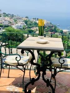 een tafel met een vaas op het balkon bij B&B L'Agapanto in Capri