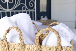 two baskets filled with towels on a table at Sunset in Megalochori