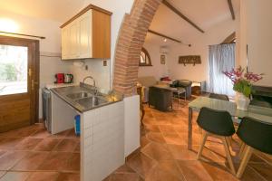 a kitchen with a sink and a table with chairs at Podere Isabella in San Vincenzo