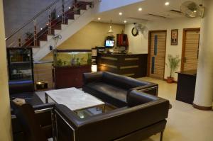 a living room with a couch and a table at Hotel Citi Heights in Chandīgarh
