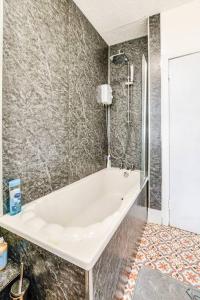 a white bath tub in a bathroom with a shower at Tiny home at Dundee in Dundee