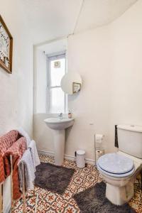 a bathroom with a toilet and a sink at Tiny home at Dundee in Dundee