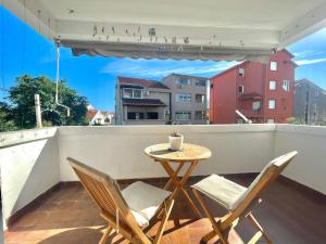a small table and two chairs on a balcony at Family One bedroom apartment with Garden view in Budva