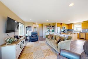 a large living room with a couch and a kitchen at Wakonda Beach Oasis in Waldport